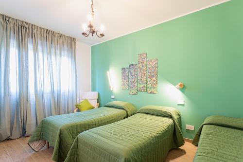 a bedroom with two beds and a painting on the wall at Dimora Il Parco in Bologna