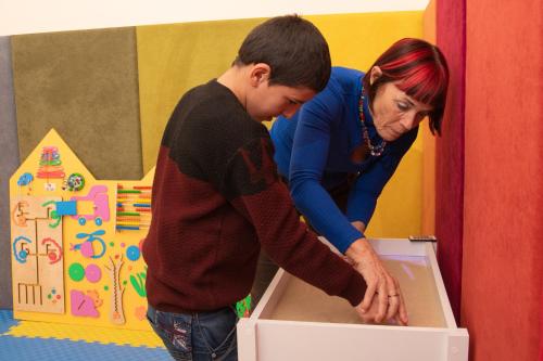 a woman helping a young boy open a box at Jermuk Ararat Health SPA in Jermuk