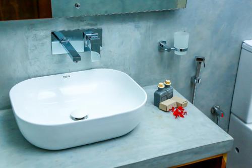 a bathroom with a white sink on a counter at Doola River Edge in Udawalawe