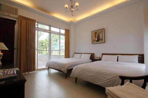 Postel nebo postele na pokoji v ubytování Nunu Haus Guest House