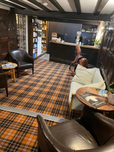 a room with a couch and chairs and a table at The Dog & Partridge Country Inn in Ashbourne