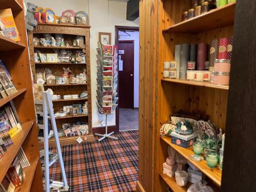 a room with wooden shelves with items on them at The Dog & Partridge Country Inn in Ashbourne