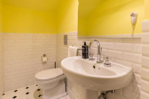 a bathroom with a white toilet and a sink at Belle Boutique in Sliema