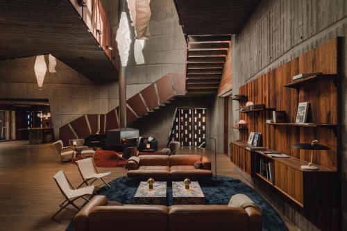 a living room with a couch and a staircase at Aethos Monterosa in Champoluc