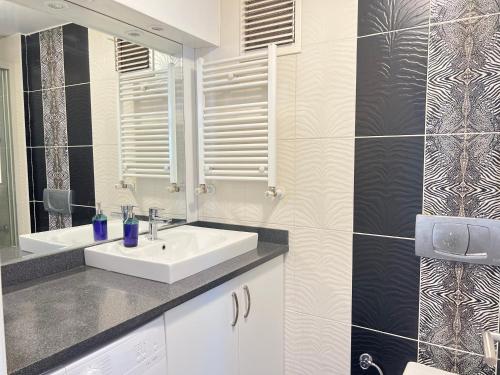 a bathroom with a sink and a mirror at New Studio Apartment, 1BR in Istanbul