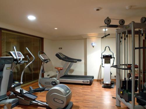 a gym with a bunch of exercise equipment in a room at Ramada By Wyndham Fes in Fès