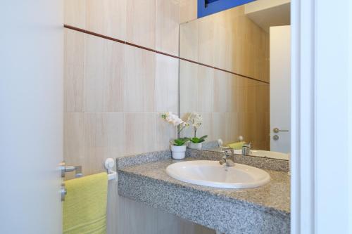 un baño con lavabo y espejo en O Nautico Laxe, en Playa Blanca