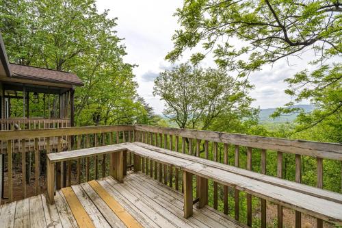 a wooden deck with a bench on a house at Mountain Ridge View 172 in Dahlonega
