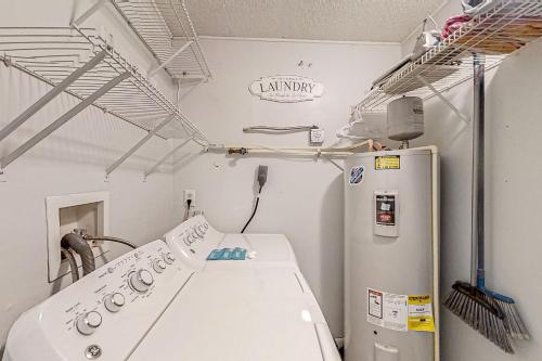 an empty room with a laboratory with a refrigerator at Dog-friendly home with fenced yard, patio, grill, & park across the street in Saint Augustine