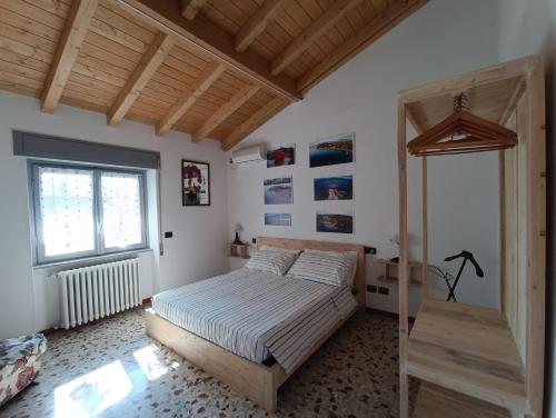 a bedroom with a bed and a window at Casa Le Fornaci in Ispra