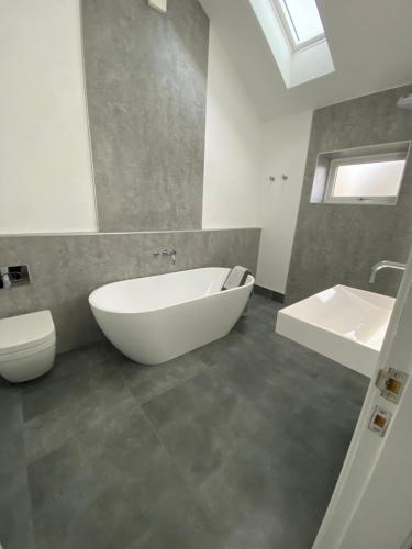 a bathroom with a tub and a toilet and a sink at New purpose built holiday lodge in Scorton