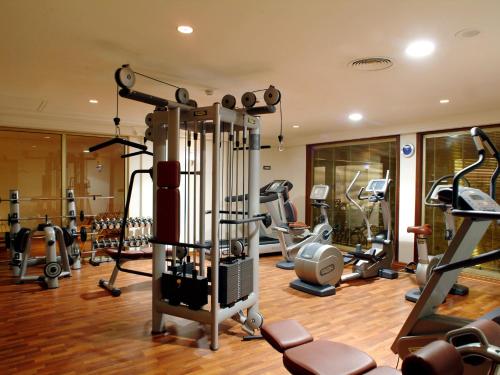 a gym with several treadmills and exercise machines at Ramada By Wyndham Fes in Fès