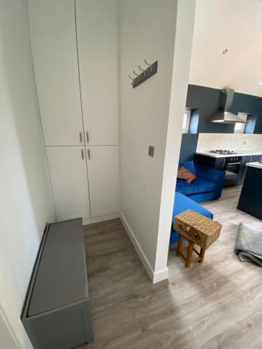 a living room with a blue couch and a table at New purpose built holiday lodge in Scorton