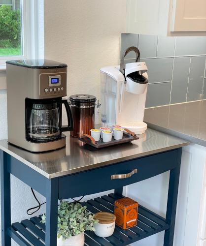 a counter in a kitchen with a coffee maker on it at Stylish townhome near AT&T Stadium, Globe Life, Six Flags & More in Arlington