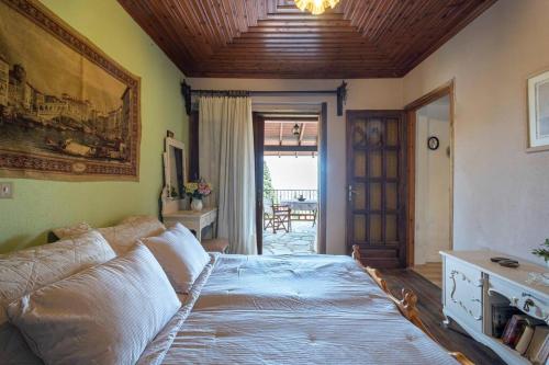 a bedroom with a large bed and a couch at Guest House Sklithro in Sklíthron