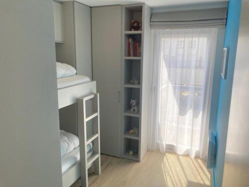 a room with a book shelf and a window at Oostduinkerke Apartments in Oostduinkerke