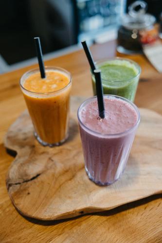 two smoothies are sitting on a wooden cutting board at OREA Resort Santon Brno in Brno