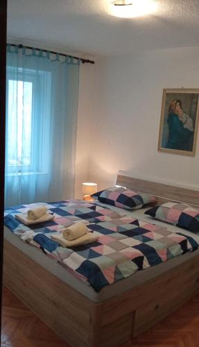 a bedroom with a bed with two pillows on it at Apartment Skale in Senj