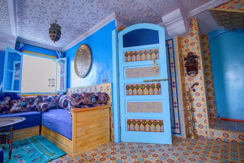 a bedroom with a blue room with a bed and a sink at Amazing view and unique design in historic medina in Chefchaouene
