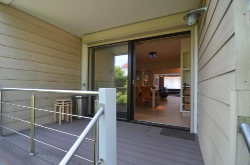 a sliding glass door on a porch of a house at Oostduinkerke Apartments in Oostduinkerke