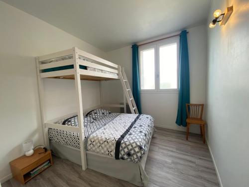 een slaapkamer met een stapelbed en een raam bij Le Parmentier - 1 place de parking privative in Saint-Aignan