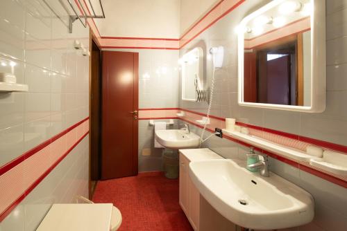 a bathroom with two sinks and a mirror at Residence La Fenice in Padova