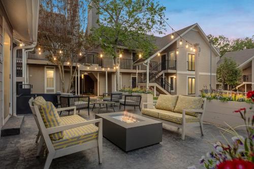 a patio with chairs and a table and a fire place at WaterWalk Extended Stay by Wyndham Atlanta Perimeter in Atlanta