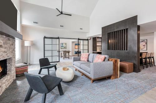 a living room with a couch and a fireplace at WaterWalk Extended Stay by Wyndham Atlanta Perimeter in Atlanta