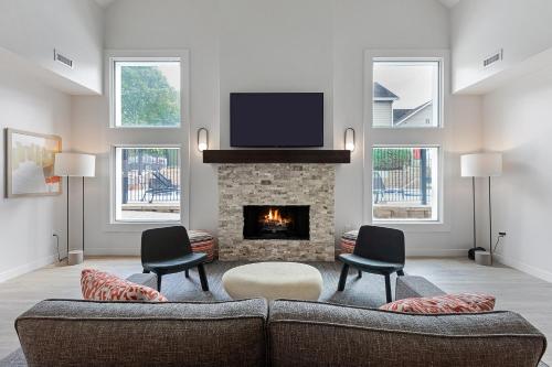 a living room with a couch and a fireplace at WaterWalk Extended Stay by Wyndham Atlanta Perimeter in Atlanta