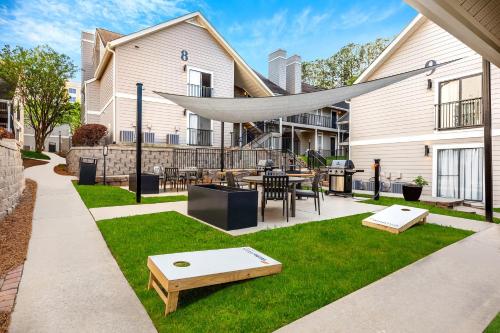 a patio with a table and chairs in a yard at WaterWalk Extended Stay by Wyndham Atlanta Perimeter in Atlanta