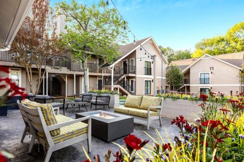 a patio with chairs and a table and some flowers at WaterWalk Extended Stay by Wyndham Atlanta Perimeter in Atlanta