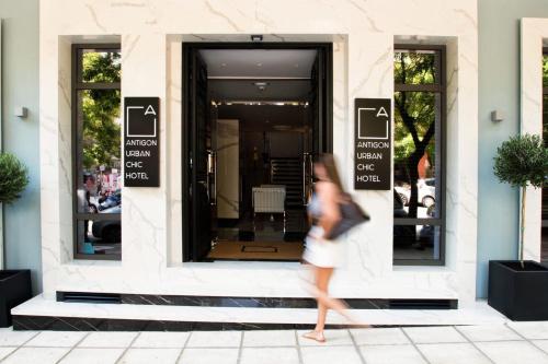 a woman walking in front of a store at Antigon Urban Chic Hotel, Thessaloniki in Thessaloniki