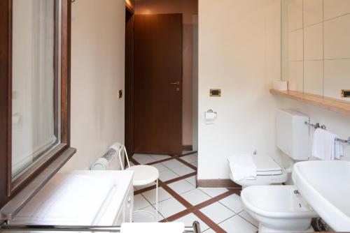 a bathroom with two toilets and a sink at Residence La Fenice in Padova