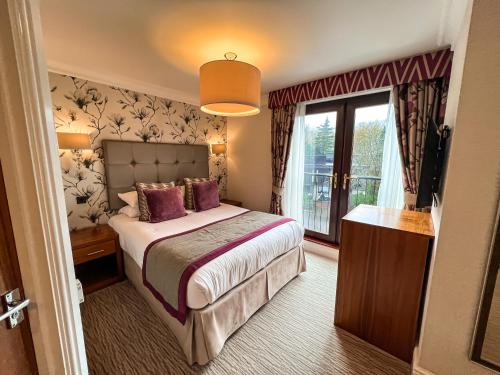 Un ou plusieurs lits dans un hébergement de l'établissement Lodore Falls Hotel & Spa