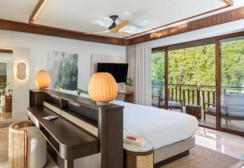 a living room with a couch and a table at Fairmont Mayakoba in Playa del Carmen