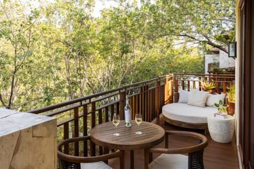 a patio with two tables and chairs on a deck at Fairmont Mayakoba in Playa del Carmen