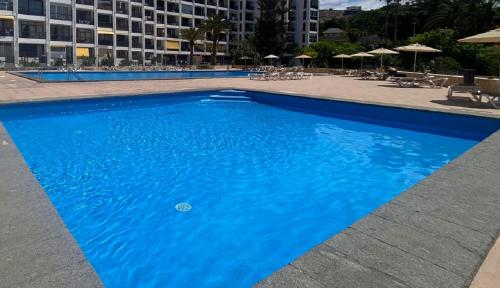 A piscina localizada em Enjoy the sea and pool in Playa de las Americas ou nos arredores