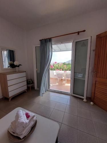 a living room with a door open to a patio at Paros Reppas House "Livadia" in Parikia
