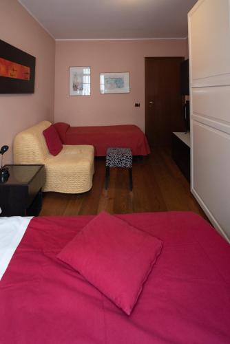 a bedroom with two beds and a red blanket at Residence La Fenice in Padova