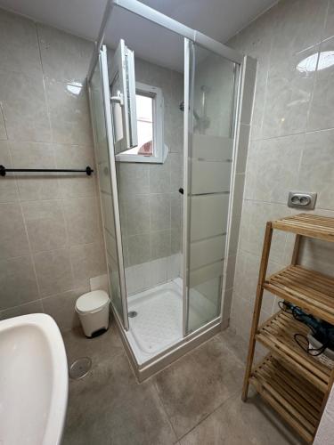 a bathroom with a shower and a toilet and a sink at Charming apartment in historic center Tarifa in Tarifa