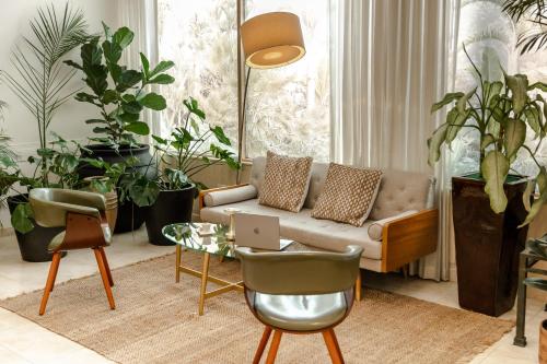 a living room with a couch and a table with a laptop at Holiday Inn Hotel Port of Miami-Downtown by IHG in Miami