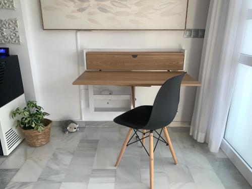 a desk and a chair in a room at Casa Hibiscus Marbella in Marbella