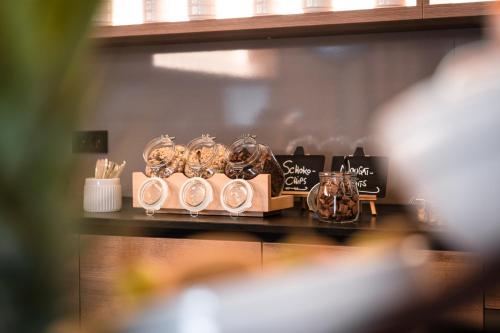 a shelf with glasses and other items on a table at Genusshotel "Zum Wendl" in Freyung
