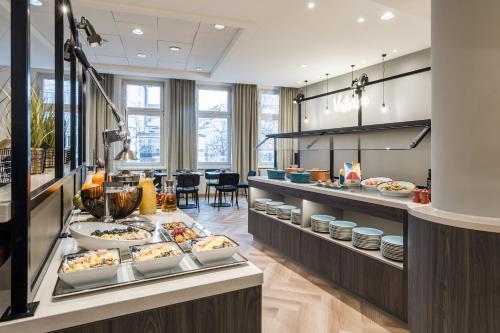 a buffet line with food on display in a restaurant at ibis Styles Bielefeld City in Bielefeld