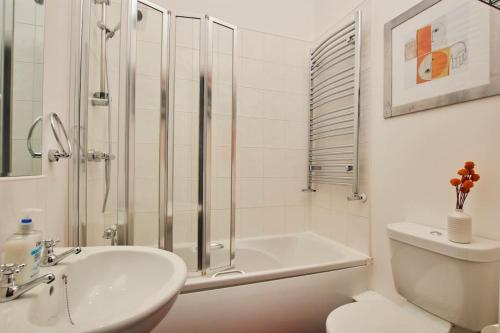 a bathroom with a shower and a sink and a toilet at Lovely Chique Newcastle Abode - Sleeps 4 in Elswick