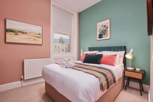 a bedroom with a large bed and a window at Lovely Chique Newcastle Abode - Sleeps 4 in Elswick