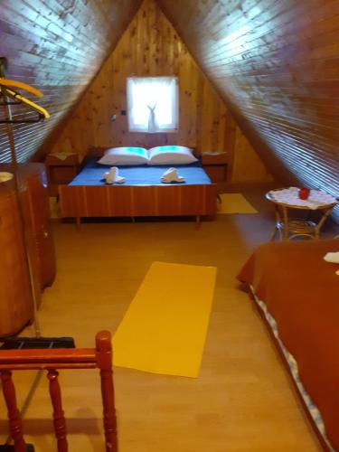 a bedroom with a bed in a attic at Matanovi dvori in Bribir