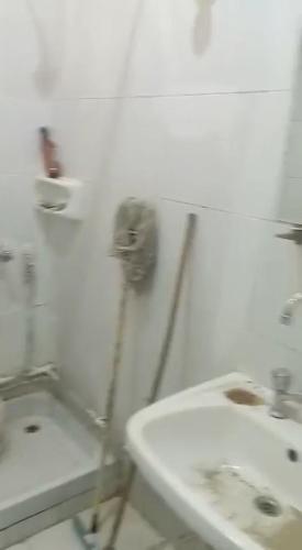 a white bathroom with a sink and a toilet at Bakar house in Shellal