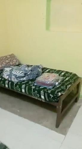 a bed with two pillows on it in a room at Bakar house in Shellal