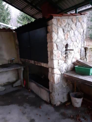 a stone fireplace in a room with a stone wall at Matanovi dvori in Bribir